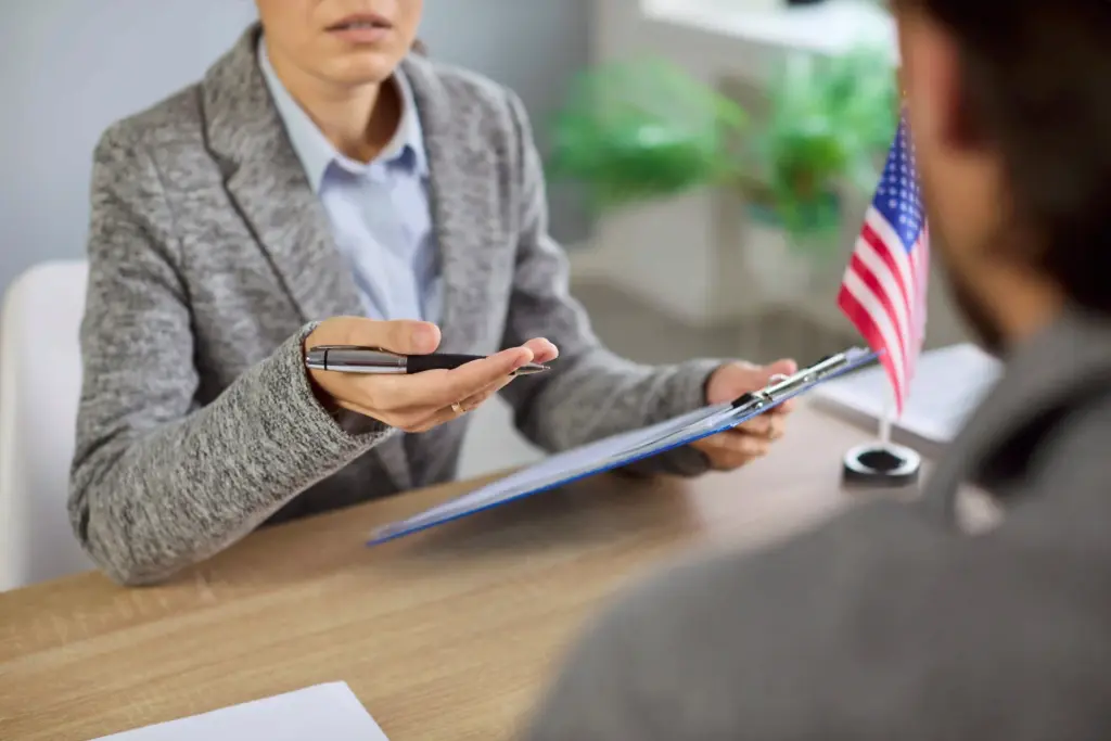 An immigration lawyer talks with a client regarding their visa application.